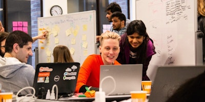 University of Washington iSchool group of students working at computers in a lab on campus.