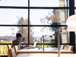 Student sitting at table on the University of Washington campus